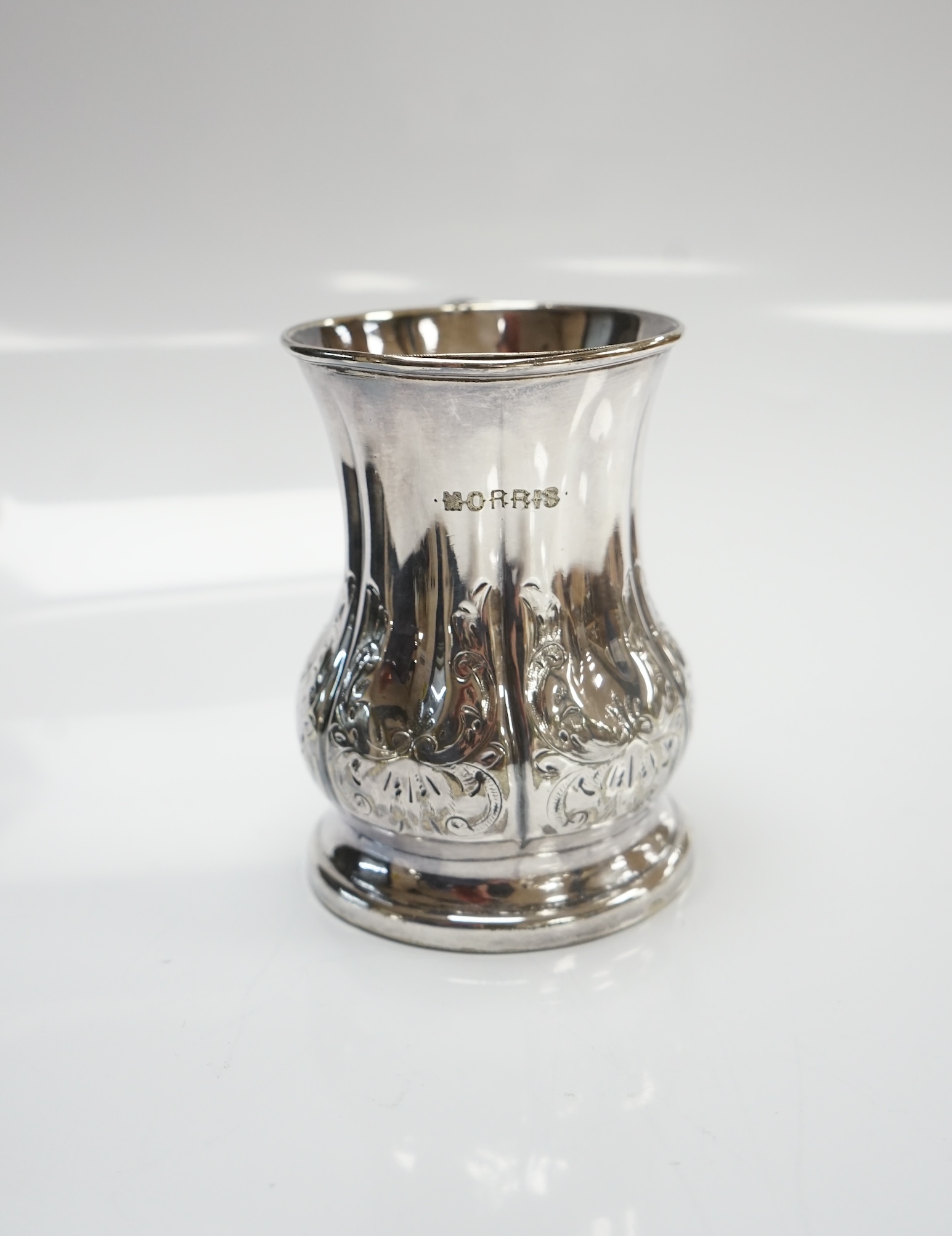 A George V silver goblet, Harrison & Sons, Birmingham, 1925, 15.3cm and a silver plated christening mug. Condition - fair